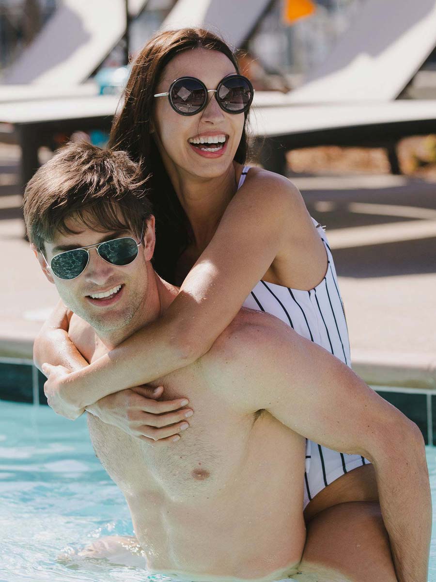 Couple enjoying pool at Fort Lauderdale luxury hotel.