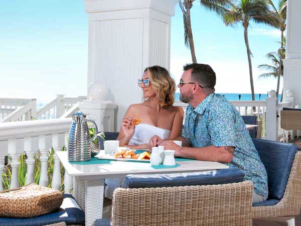 Couple eating breakfast on the veranda.