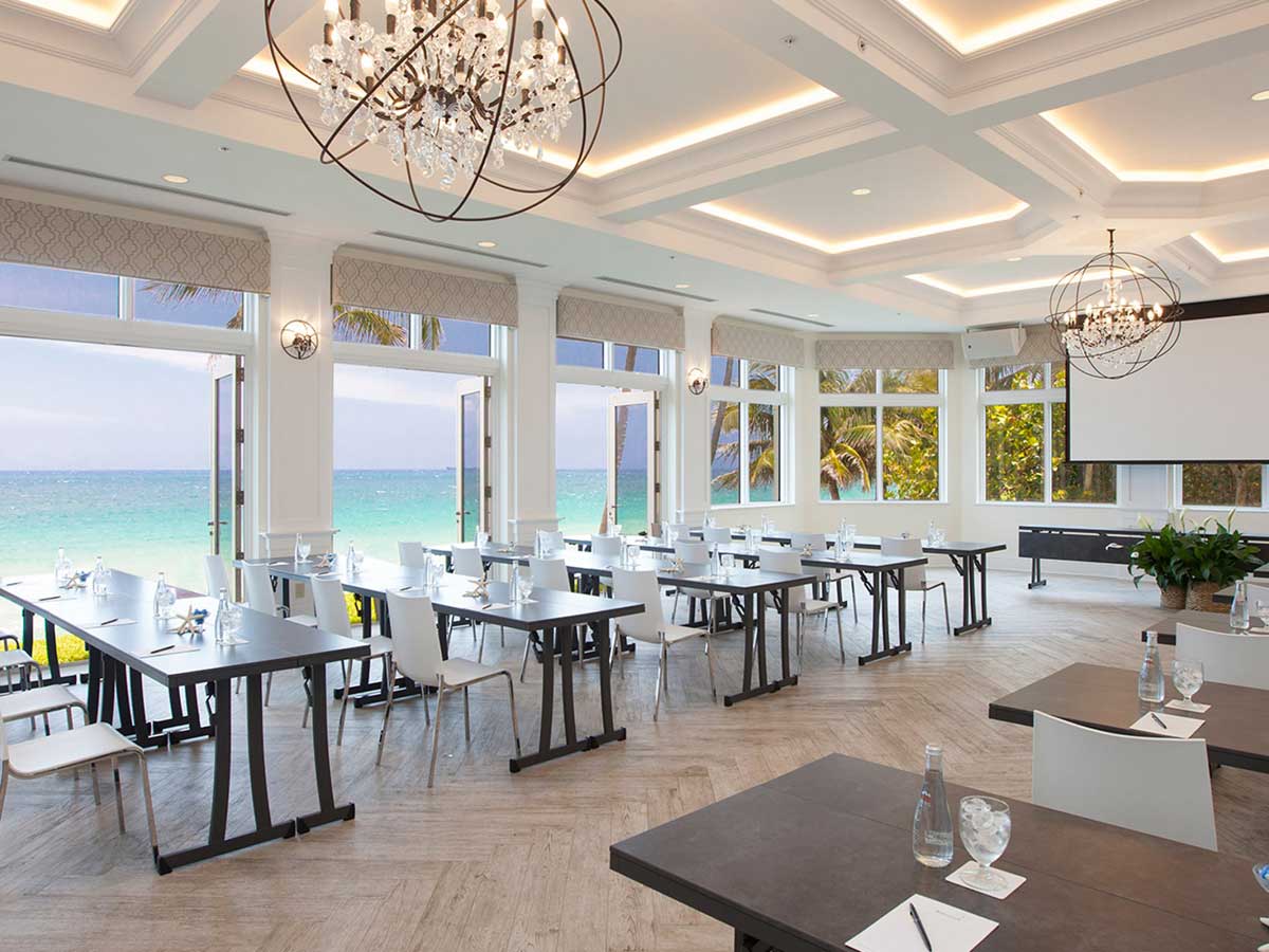 a hotel dinning area where tables are arranged in columns