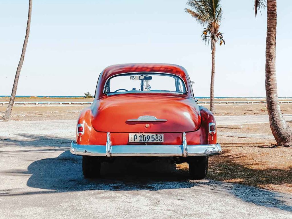 The back of a car parked near the beach.