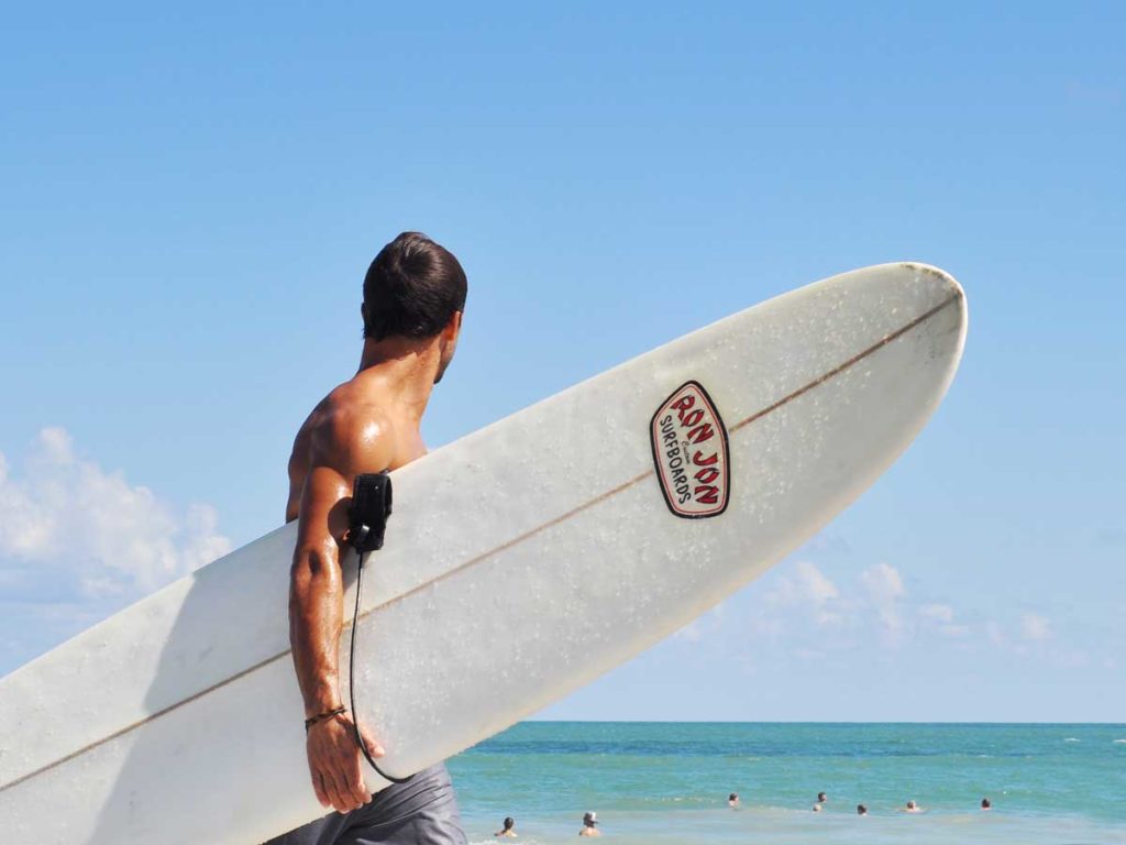 A guy going surfing.