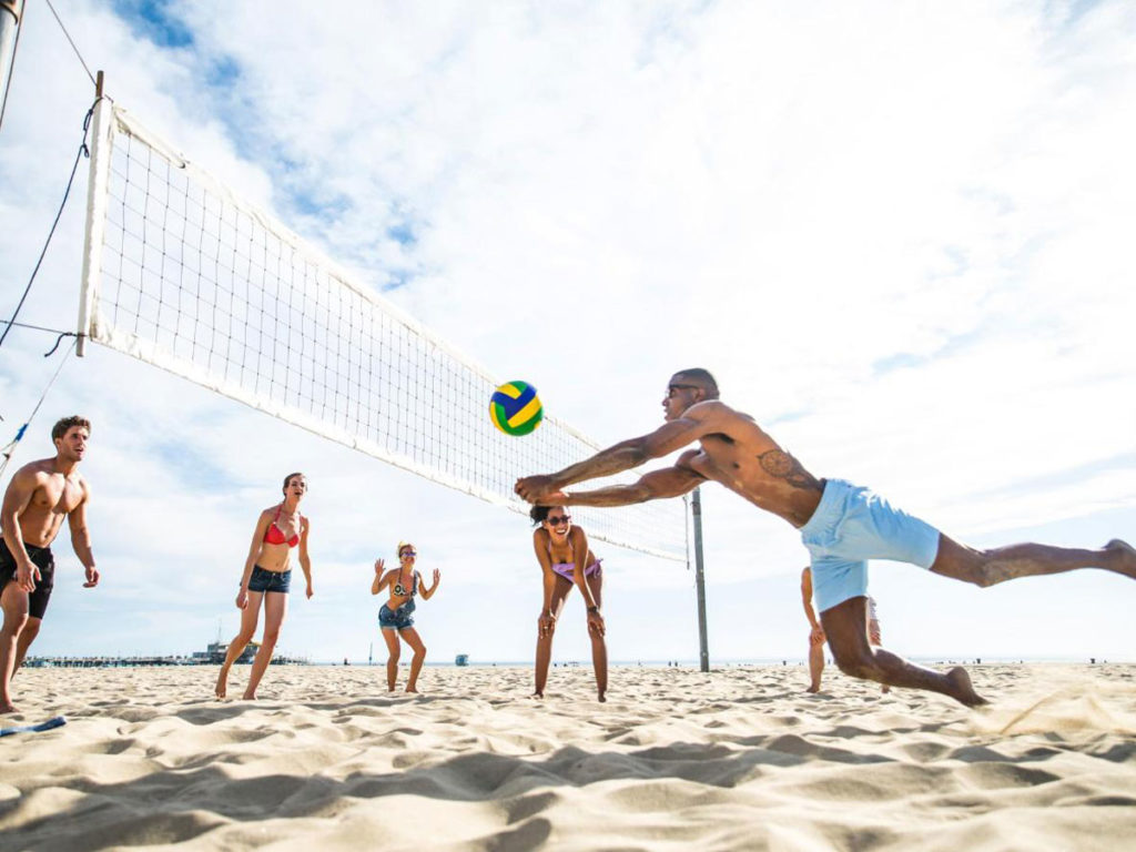 playing volleyball on beach