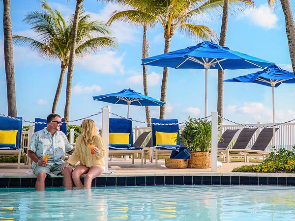 Couple With Drinks By The Pool