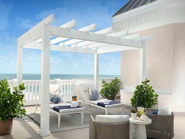 Oceanfront spa cabana with white pergola, chaise lounges, and Atlantic views at Pelican Grand Beach Resort in Fort Lauderdale, Florida